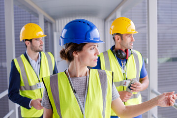 Supervisors and worker with clipboard in factory