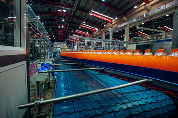 Beverage factory interior. Conveyor flowing with bottles for juice