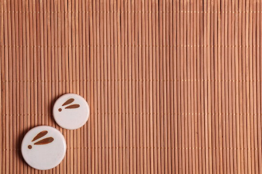 Japanese backgound. chopstick stands with the image of a moon rabbit on the background of a bamboo mat. The concept of the mid-autumn