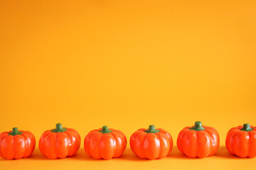 Halloween pumpkins decoration on yellow background, space for text. Halloween concept