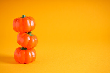 Halloween pumpkins on yellow background, space for text. Halloween concept.