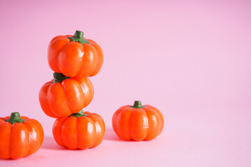 Halloween pumpkins on a pink background, space for text. Halloween concept.
