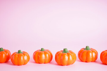 Halloween pumpkins on a pink background, space for text. Halloween concept