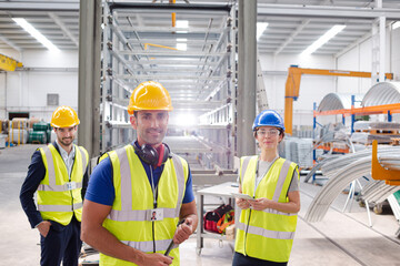 Smiling workers talking in factory