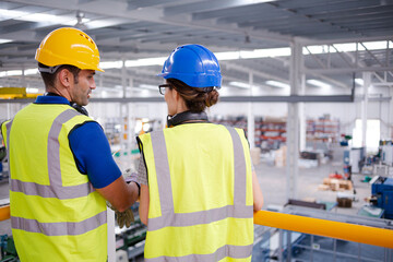 Supervisor and worker talking in steel factory