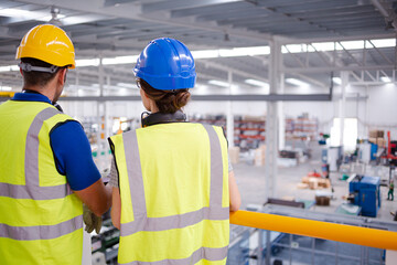 Supervisor and worker talking in steel factory