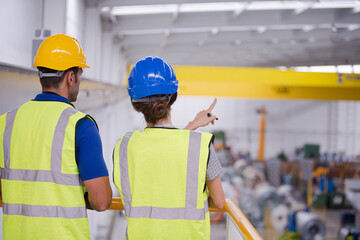 Supervisor and worker in factory