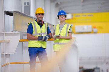 Supervisor and worker in steel factory