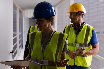 Supervisors and worker with clipboard in factory