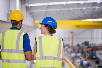 Supervisor and worker in factory