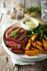 Beef steak with roasted potato and salad