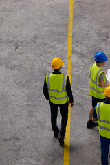 Supervisor and workers walking in factory