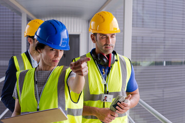 Supervisors and worker in steel factory