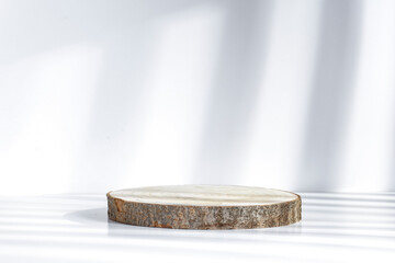 Minimalist pedestal on a white background with sun shadows and blank space for your advertising product