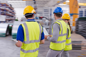 Supervisor and workers talking in warehouse