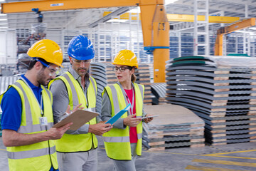 Workers talking in steel factory