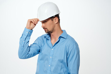 male builder with drawings in hand hand gesture light background