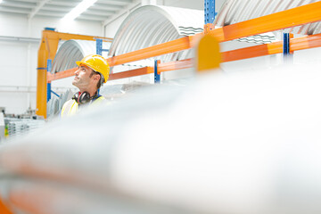Naklejka premium Male worker looking up in factory