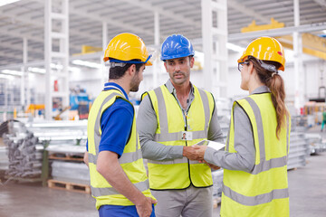 Supervisor and workers talking in steel factory