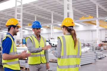 Supervisor and workers talking in steel factory