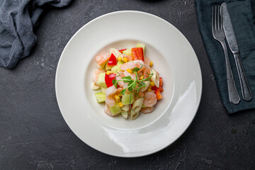 Salad with shrimp and vegetables, Chinese cuisine on black stone table top view