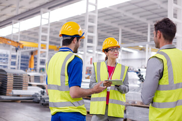 Supervisor and workers talking in steel factory