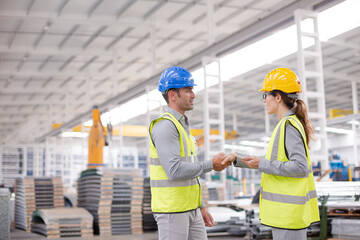 Supervisors handshaking in warehouse