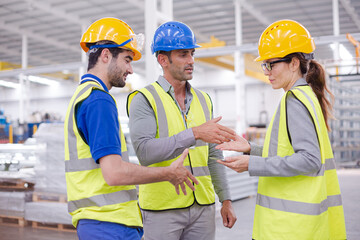Supervisor and workers talking in steel factory