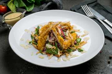 Vietnamese salad with vegetables and chicken on dark stone table