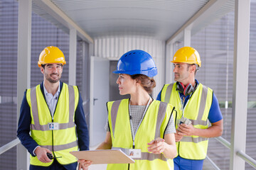 Supervisors and worker with clipboard in factory