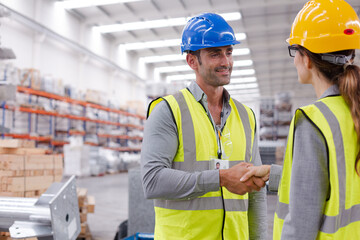 Supervisors handshaking in warehouse