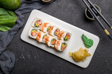 roll with spicy shrimp and crab on dark stone table top view