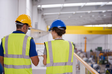 Supervisor and worker in factory