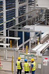 Supervisor and workers talking in factory