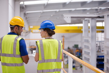 Supervisor and worker in factory