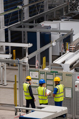 Supervisor and workers talking in factory