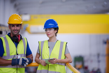 Supervisor and worker in steel factory