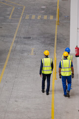 Supervisor and workers talking in factory