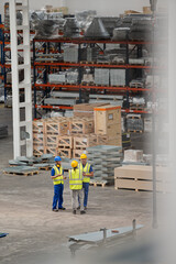 Workers and supervisor talking in factory