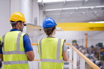 Supervisor and worker in factory