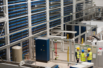 Supervisor and workers talking in factory