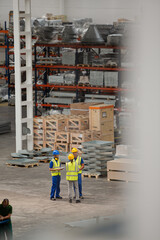 Workers and supervisor talking in factory