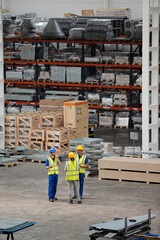 Workers and supervisor talking in factory