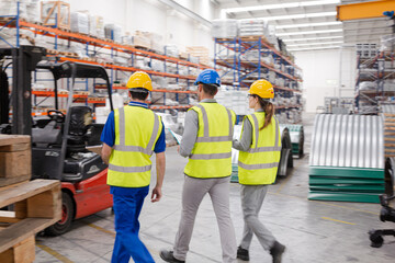 Supervisor and workers talking in warehouse