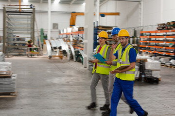 Supervisor and workers talking in warehouse