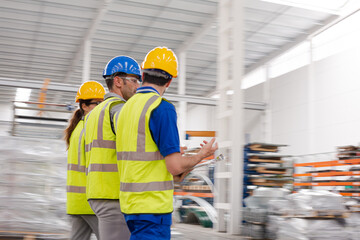 Supervisor and workers talking in warehouse