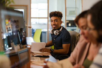 Smiling young man working at desk