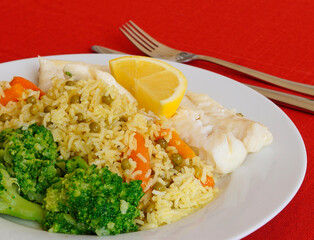 a platter with delicious codfish dish with rice and vegetables