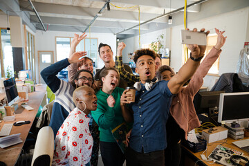 Team taking group selfie in office