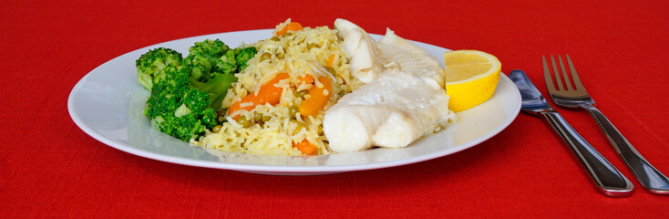 a platter with delicious codfish dish with rice and vegetables